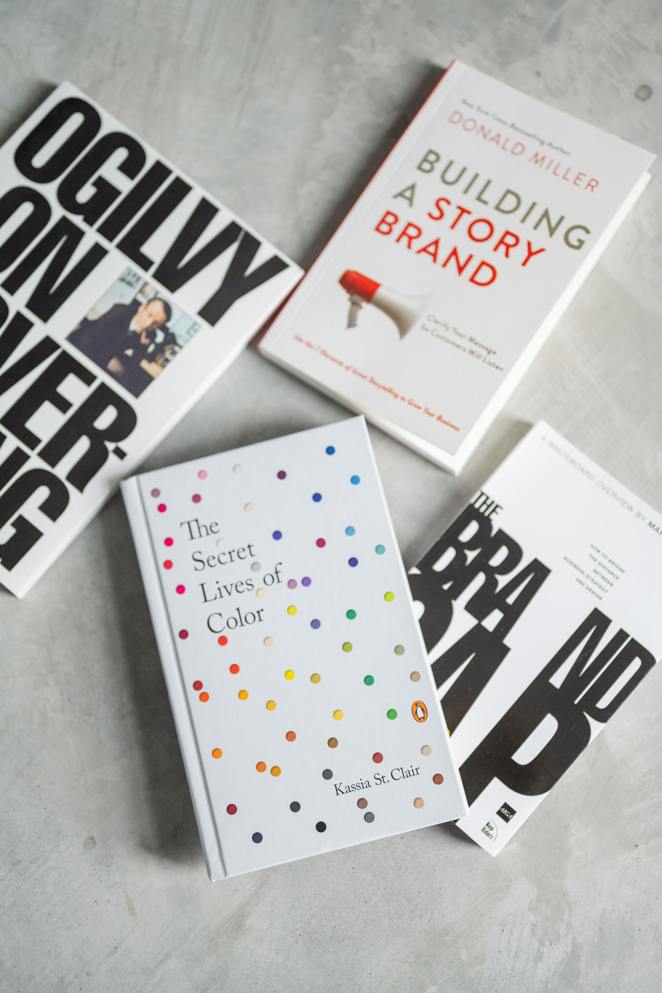 Four books on branding scattered out on the floor