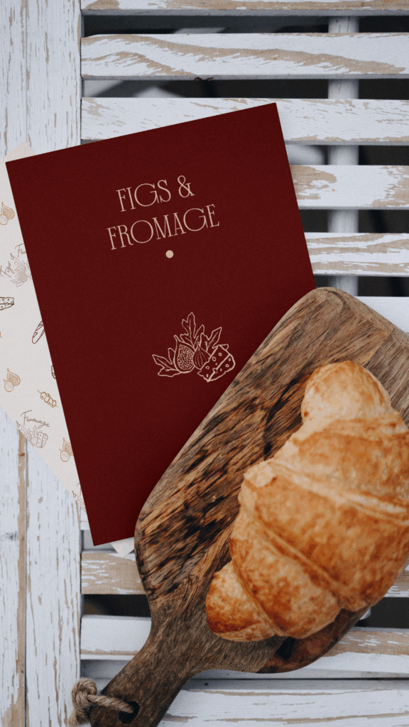 Red Card with charcuterie business logo with bread and wooden board in the background.