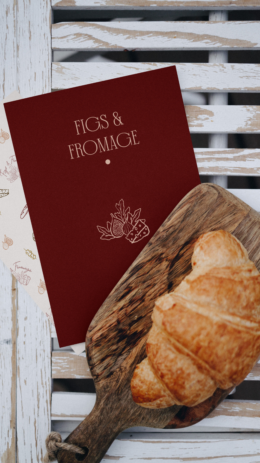 Red card with charcuterie business logo with bread in a wooden board.