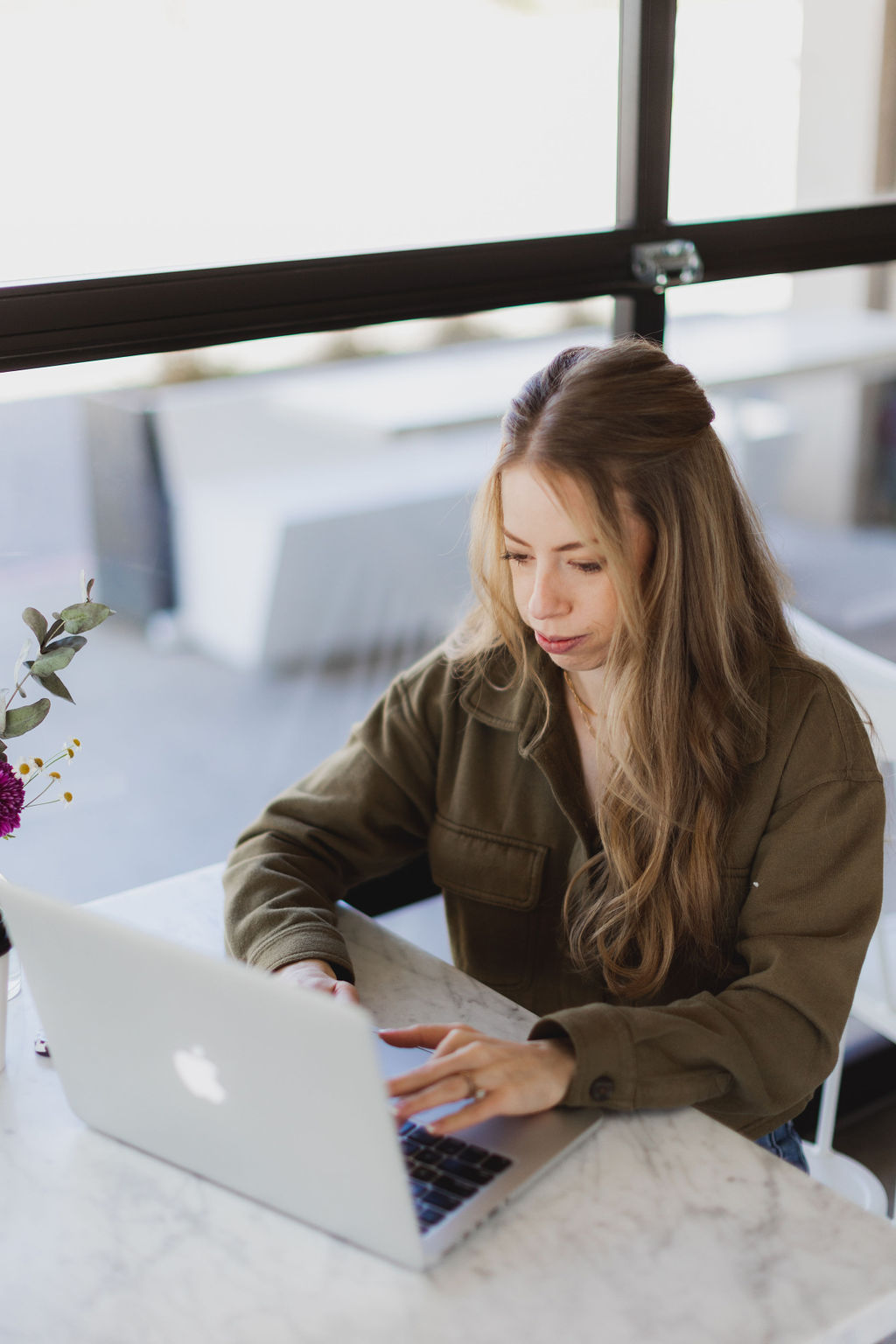 Emma Rodger, founder of Saltd Studio, working at her laptop.