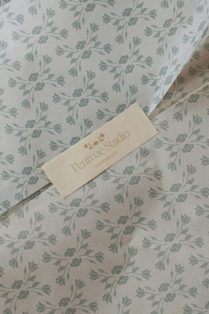 Sticker tape featuring the Penrose logo, shown with floral patterned stationery.
