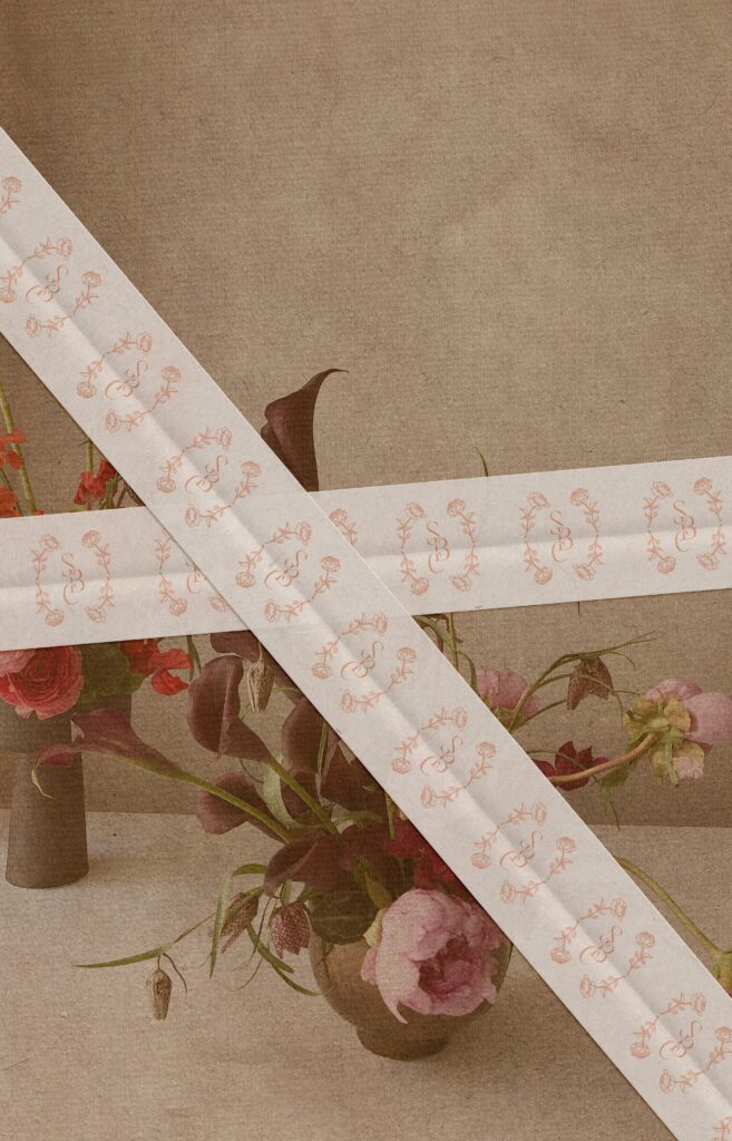 Floral branding displayed on a tape mockup against a floral background.