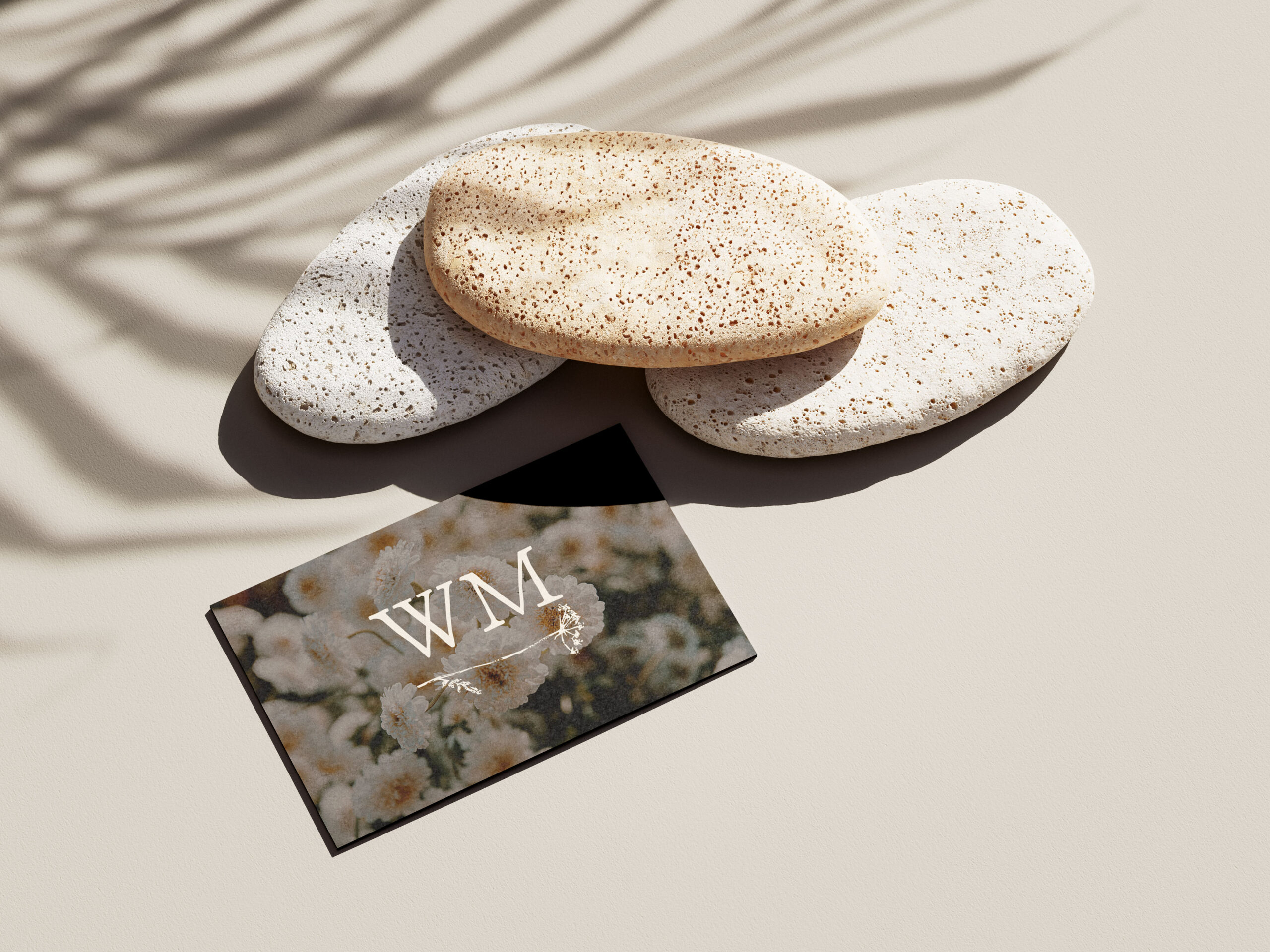 A card with the Wrenmere logo on an aesthetically arranged desk.