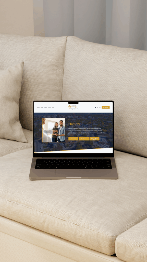 A laptop on a couch with a property management website design by Saltd Studio