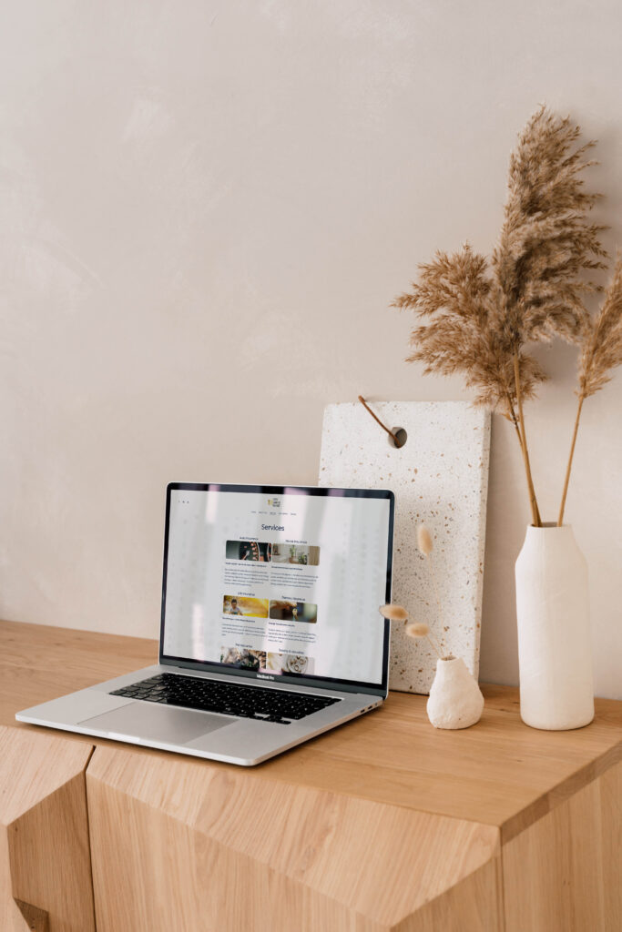 Aesthetic setup with a laptop displaying the insurance broker website