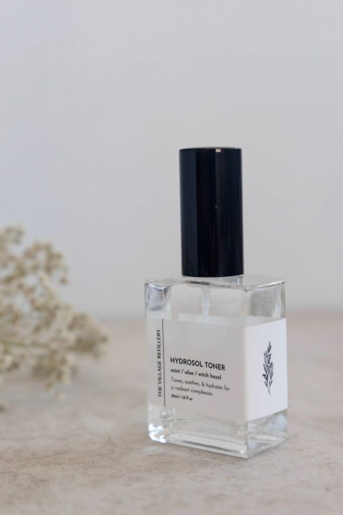 Square bottle with Village Refillery’s nature-themed branding illustrations.