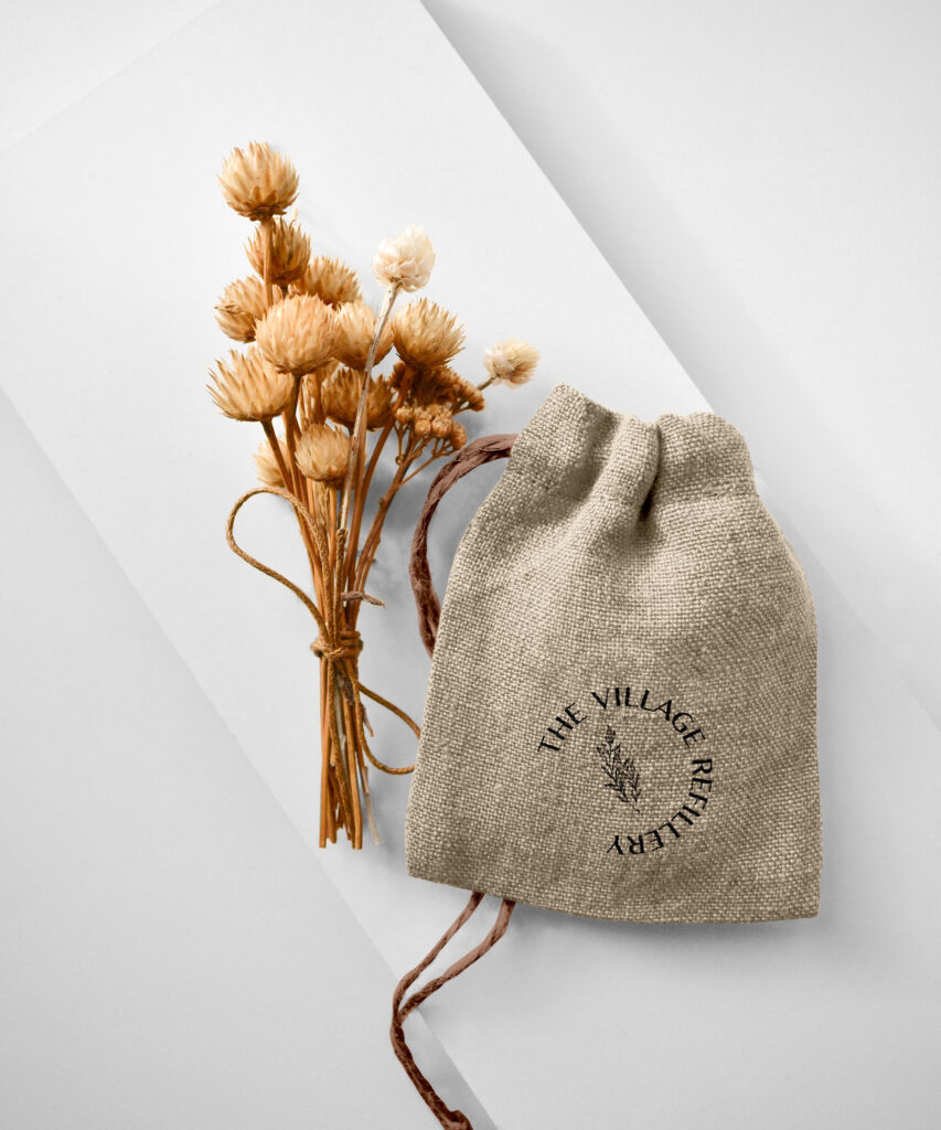 Fiber drawstring pouch with the Village Refillery logo.