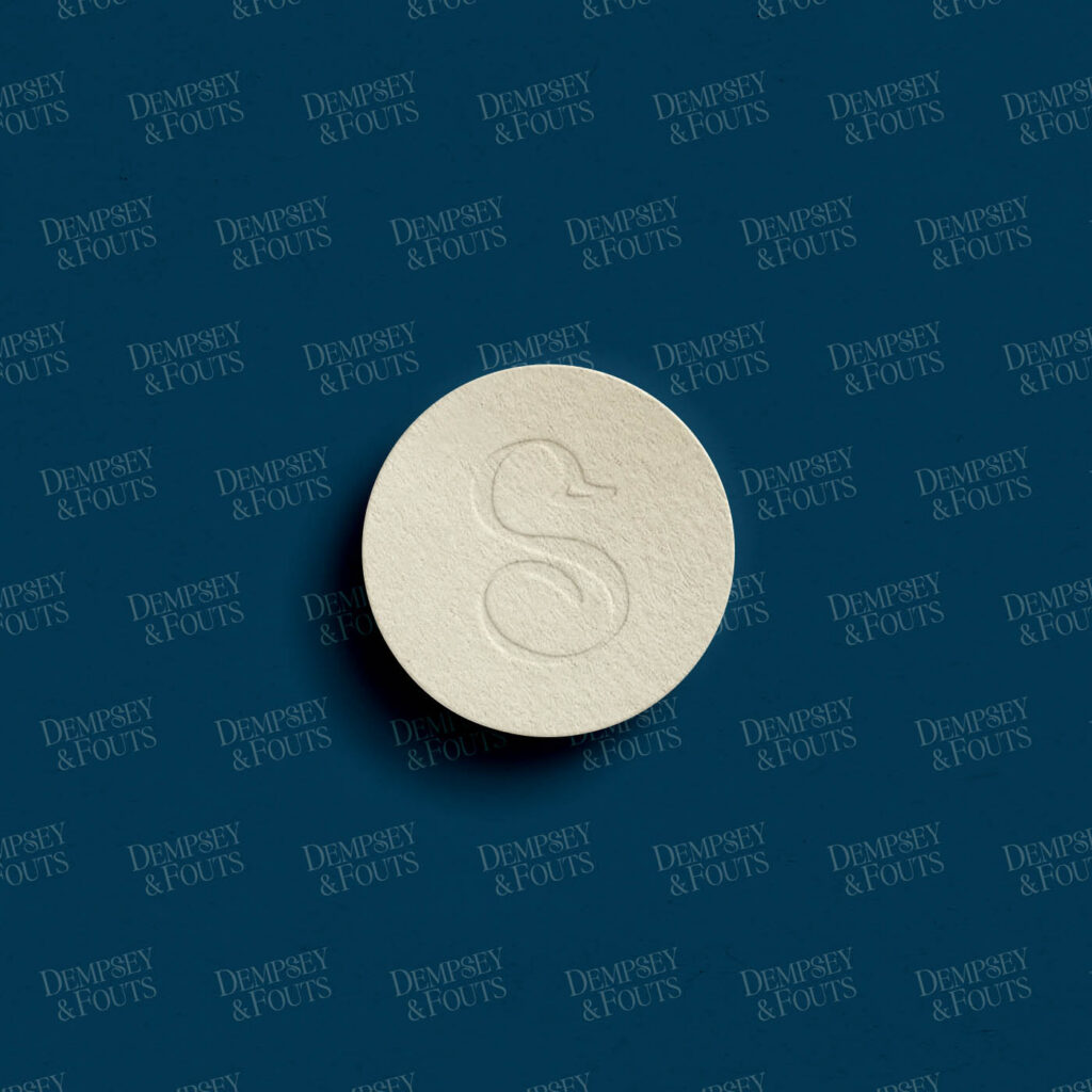 Embossed sub-mark logo for Phoenix law firm Dempsey & Fouts on patterned paper background.