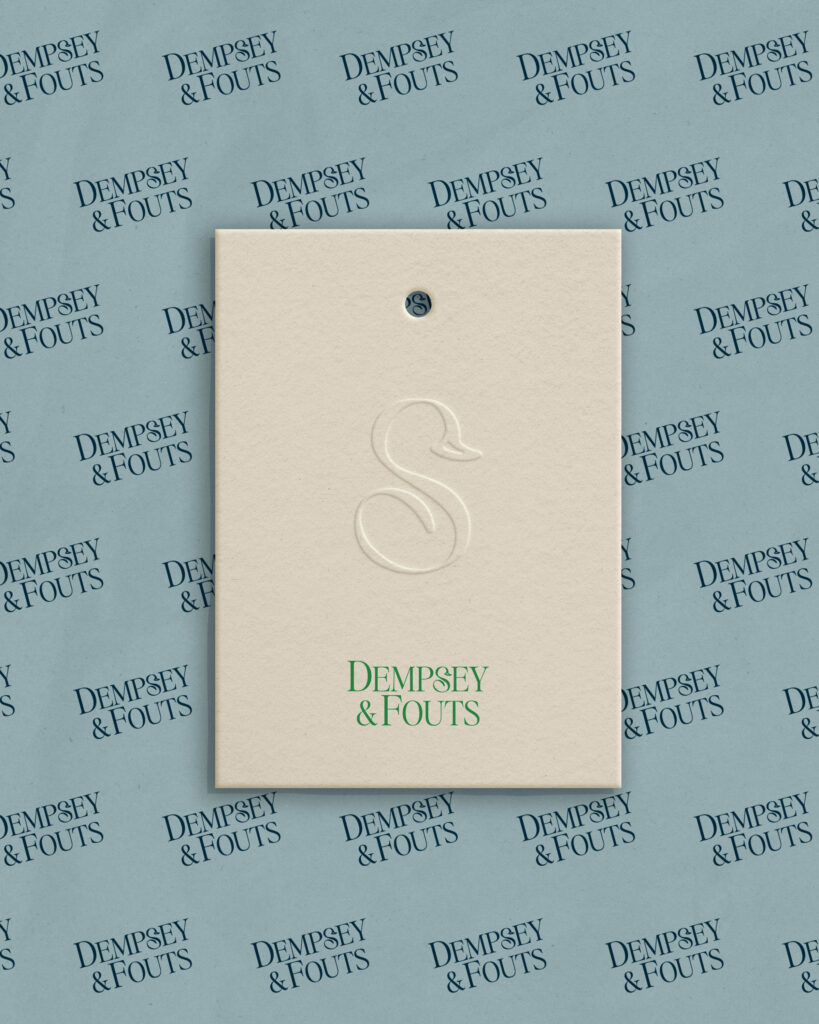 Embossed sub-mark and main logo design for Phoenix, AZ law firm on branded patterned hang tag.