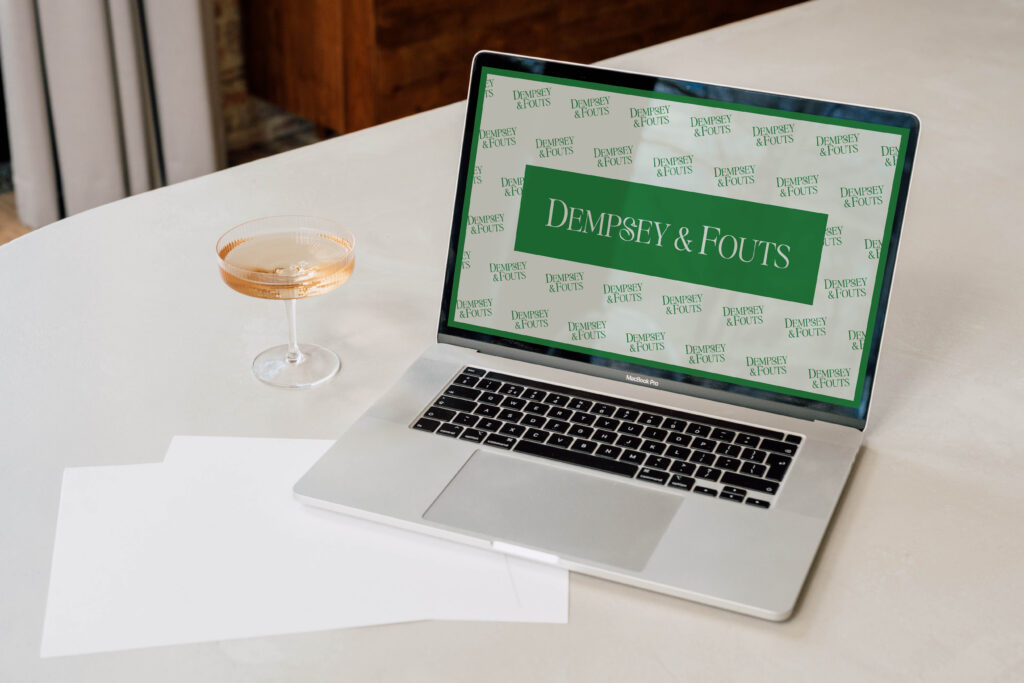 Laptop mockup displaying the Dempsey & Fouts custom branding and website design.