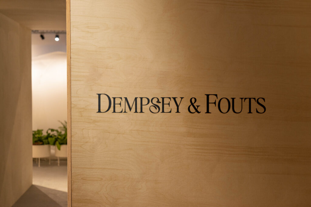 Dempsey & Fouts law firm logo displayed on an office wall.