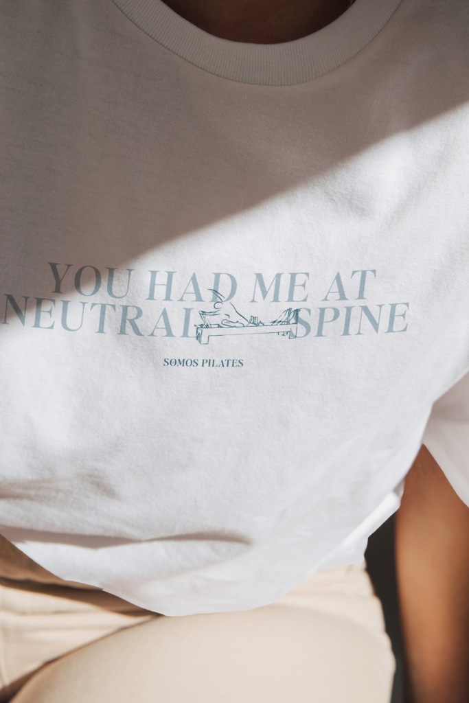 Somos Pilates brand identity featured in a T-shirt mockup.