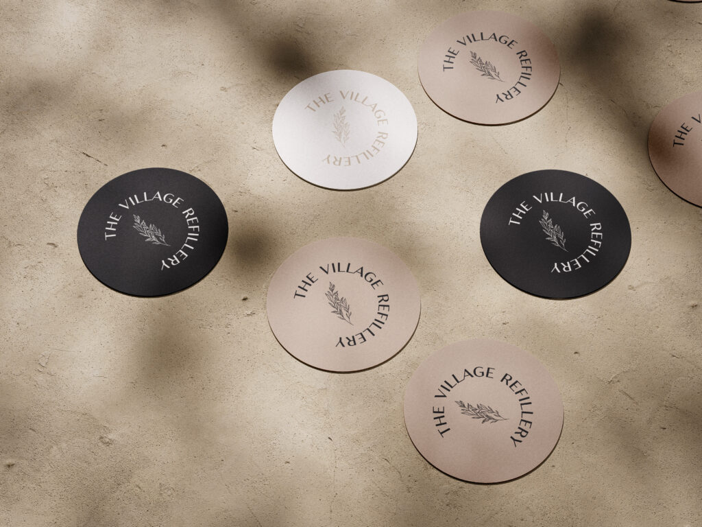 Village Refillery neutral color palette featured in a branded sticker mockup.