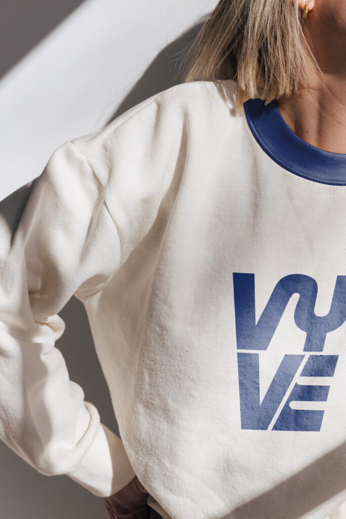 Vyve bold logo design displayed on a sweater.