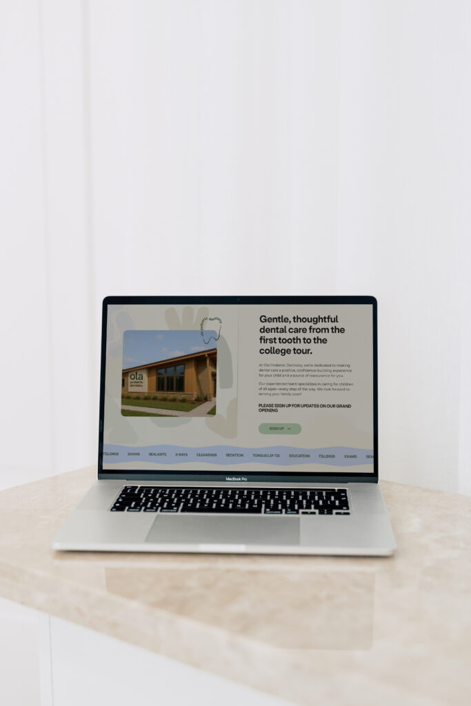 Ola Pediatric Dentistry website homepage displayed on a laptop screen.
