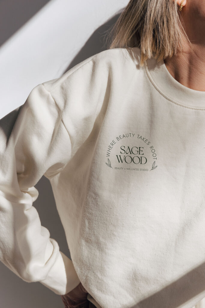 Sagewood submark logo printed on a sweater.