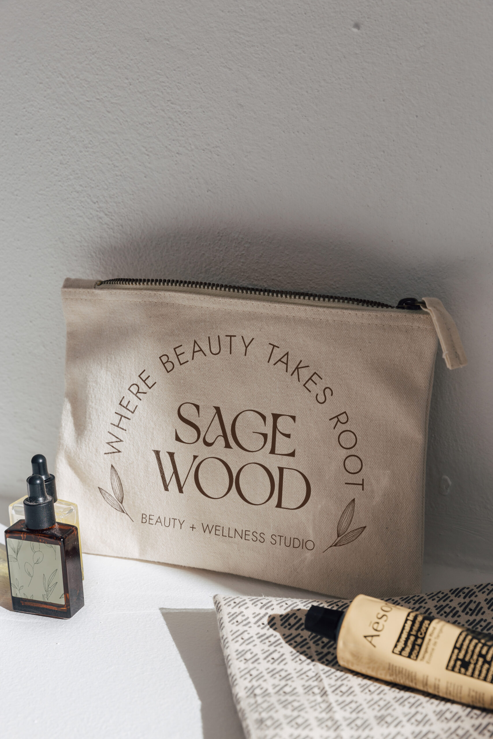 Sagewood logo and tagline on a cosmetics bag.