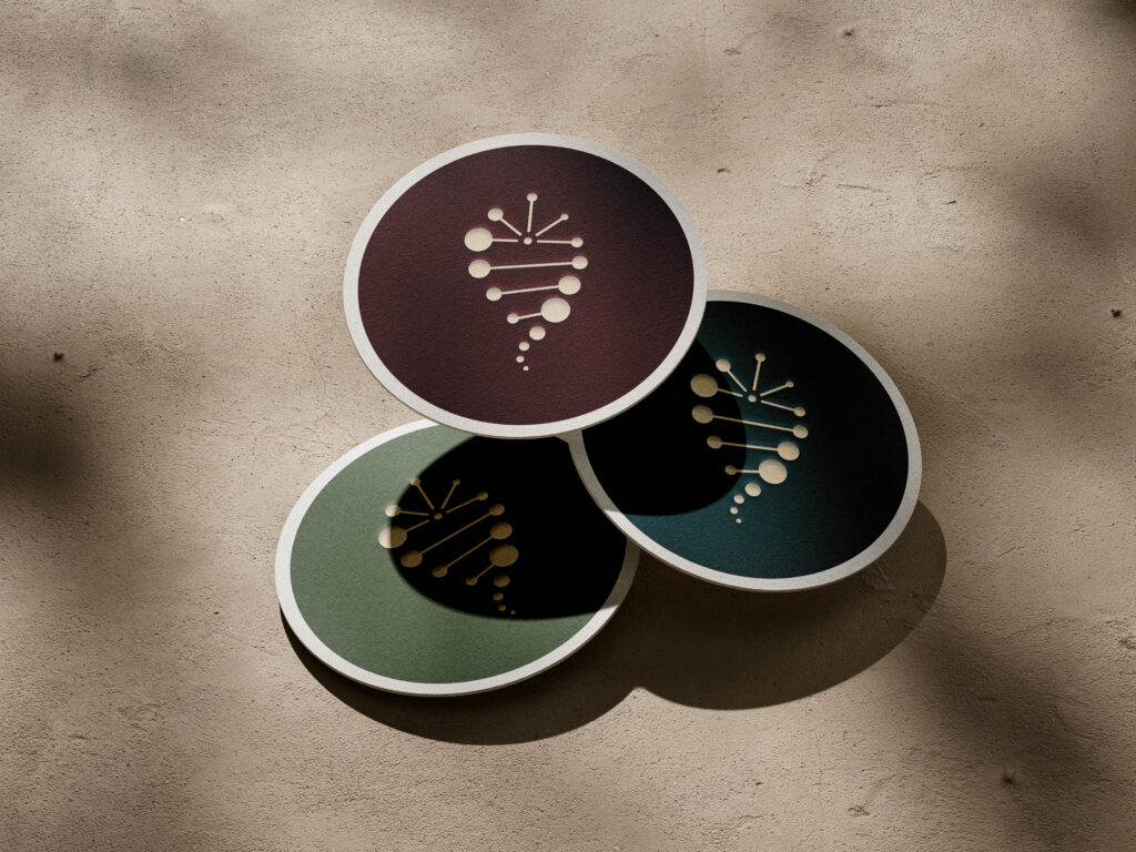 Minimal cannabis logo design for Tranquil Gardens displayed on circular pads.