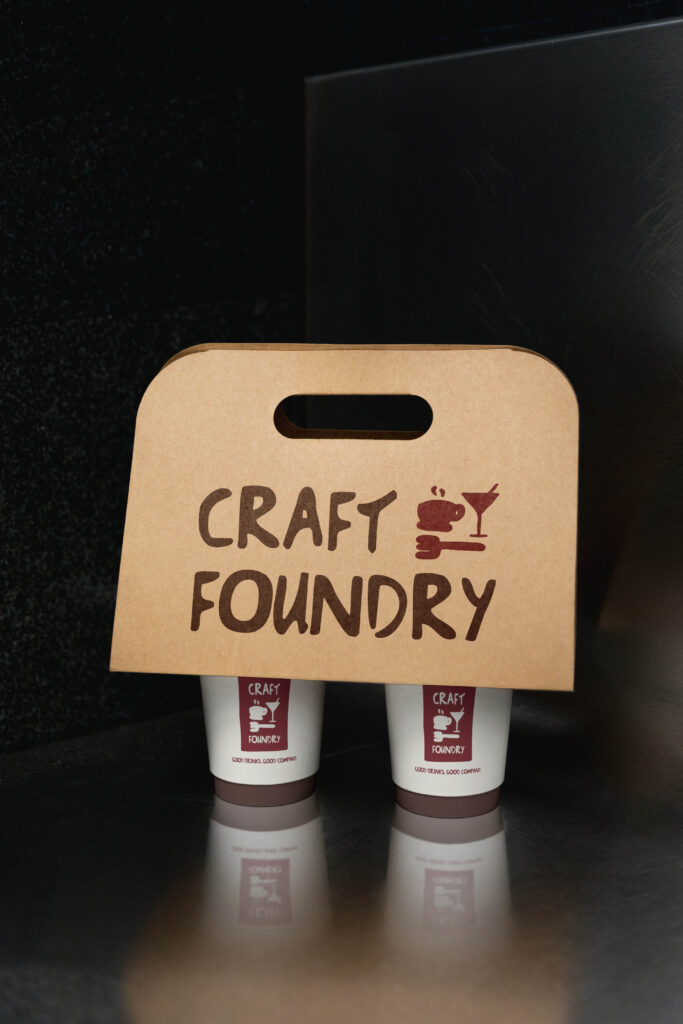 The Craft Foundry pre-made brand kit logo showcased on a coffee cup handle.
