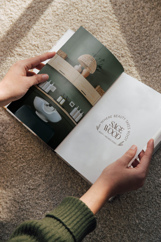 Printed Sagewood Wellness hair salon logo displayed in a magazine