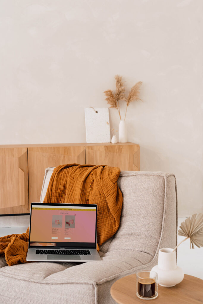The Kindred Coffee Club homepage displayed on a laptop placed on a chair. 