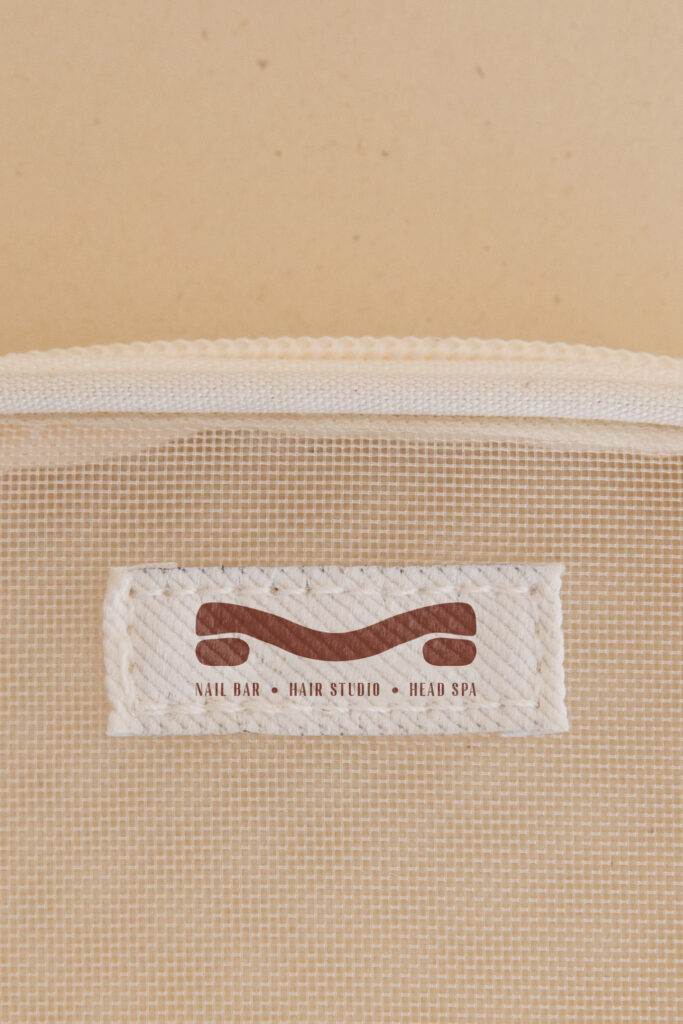 Close-up of a woven fabric tag with the Mesh Hair logo