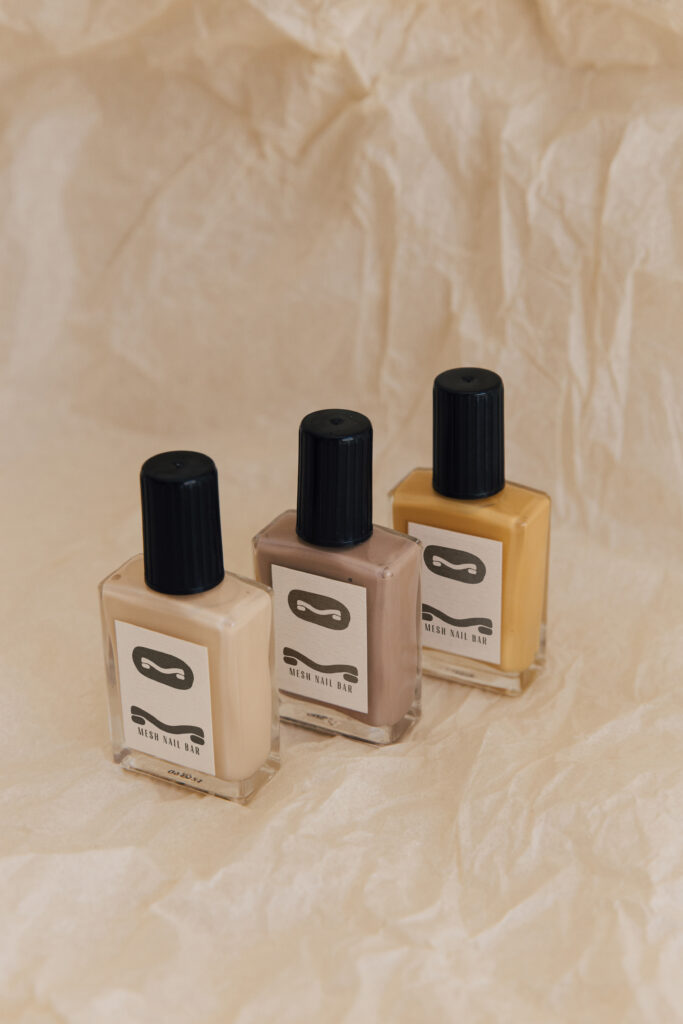 Mesh Hair beauty salon branding displayed on nail polish bottles