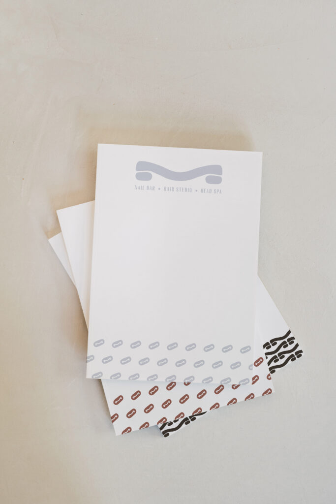 Mesh Hair logo and branding applied across stationery items