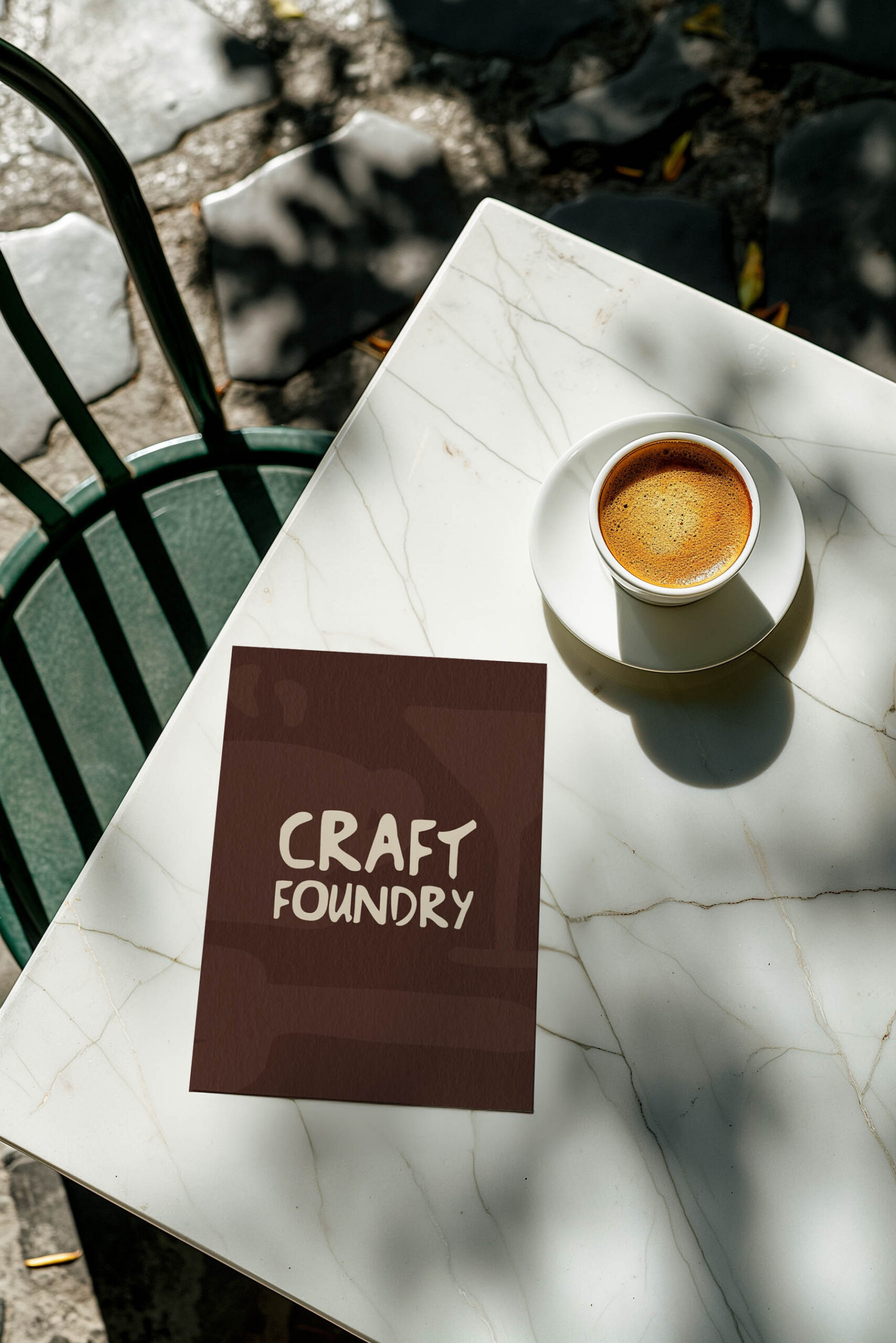 Our pre-made brand kit, Craft Foundry logo displayed on a card next to a cup of coffee.