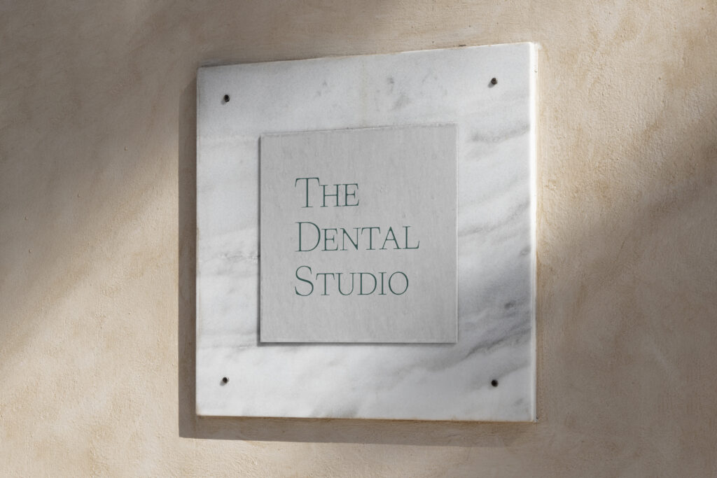 The Dental Studio logo showcased in a framed sign.